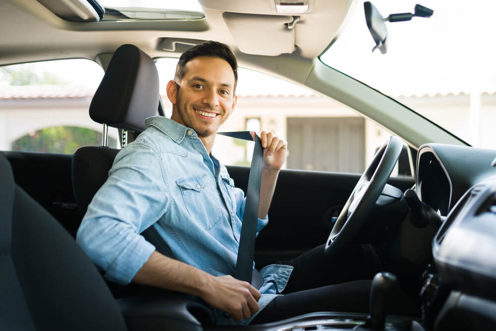 Portrait of a man smiling before starting a car.